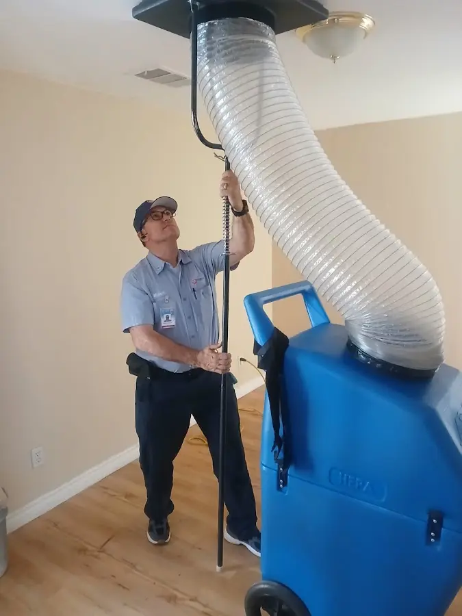 Furnace Tune-Up technician using HEPA equipment in Benbrook